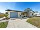 Charming house with a blue garage door, well-kept lawn, and modern landscaping, offering curb appeal and a welcoming entrance at 105 12Th Sw St, Ruskin, FL 33570