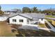 The backyard boasts a screened patio and stone path showcasing relaxed outdoor living and the well-maintained landscaping at 105 12Th Sw St, Ruskin, FL 33570