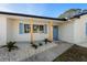 Bright front entrance featuring natural wood pillars and light blue door and shutters at 105 12Th Sw St, Ruskin, FL 33570