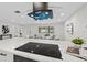 Modern kitchen island with cooktop, open design, and view of the living area at 105 12Th Sw St, Ruskin, FL 33570
