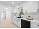 Bright kitchen features white cabinets, sleek black hardware, and stainless steel appliances at 105 12Th Sw St, Ruskin, FL 33570