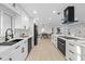 Well-lit kitchen with stainless steel appliances, modern cabinetry, and open floor plan at 105 12Th Sw St, Ruskin, FL 33570