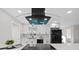 Bright kitchen with stainless steel appliances, modern cabinetry, and stylish range hood at 105 12Th Sw St, Ruskin, FL 33570