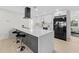 Modern kitchen with large quartz countertop island, sleek black appliances, and bar stool seating at 105 12Th Sw St, Ruskin, FL 33570