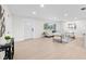 Bright living room with modern furniture, large windows, and light wood floors at 105 12Th Sw St, Ruskin, FL 33570