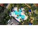 Aerial view of a resort-style community pool with palm trees and seating areas at 12417 Adventure Dr, Riverview, FL 33579