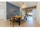 Charming dining area with a wooden table, tile flooring, and gray accent wall at 12417 Adventure Dr, Riverview, FL 33579