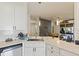 Stylish kitchen featuring marble countertops, stainless steel sink and a view of the dining room at 12417 Adventure Dr, Riverview, FL 33579