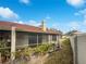 View of screened-in back porch and side yard under a bright blue sky at 18315 Aintree Ct, Tampa, FL 33647