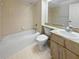 Bathroom featuring a combined tub and shower, vanity, and tile flooring at 18315 Aintree Ct, Tampa, FL 33647