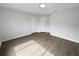 Neutral bedroom with light wood-look flooring and two white doors at 18315 Aintree Ct, Tampa, FL 33647