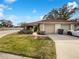 Charming home featuring a red tile roof, well-maintained landscaping, and an attached two-car garage at 18315 Aintree Ct, Tampa, FL 33647