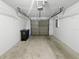 A clean, empty garage with a gray door and white walls at 18315 Aintree Ct, Tampa, FL 33647