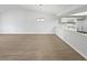 Bright living room with a vaulted ceiling, chandelier, and light wood-look flooring at 18315 Aintree Ct, Tampa, FL 33647