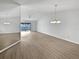 Spacious living room with a high ceiling, light wood-look flooring, and sliding glass doors at 18315 Aintree Ct, Tampa, FL 33647