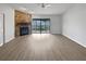 Bright living room with a statement stone fireplace and sliding door access to the outdoors at 18315 Aintree Ct, Tampa, FL 33647