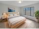 Serene main bedroom with a light wood bed frame, neutral palette, and a large picture window at 18315 Aintree Ct, Tampa, FL 33647