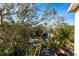 Lush waterfront landscape surrounds a dock for boating with a canopy of trees at 3107 Pine St, Bradenton, FL 34208