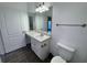 Bathroom with a vanity, large mirror, modern lighting, and a toilet at 10412 Villa View Cir # 10412, Tampa, FL 33647