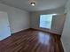 Bedroom featuring wood floors, white walls, window with blinds, and closet doors at 10412 Villa View Cir # 10412, Tampa, FL 33647