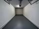 Clean, empty garage with painted floor and automatic door opener at 10412 Villa View Cir # 10412, Tampa, FL 33647