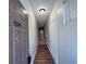 Welcoming hallway with wood floors, leading to stairs and interior doors at 10412 Villa View Cir # 10412, Tampa, FL 33647