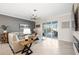 Bright living room with tile flooring, a ceiling fan, and sliding glass doors to the outdoor patio at 11400 Burgundy Dr, Venice, FL 34293