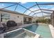 Inviting screened pool area with a hot tub and outdoor seating at 11400 Burgundy Dr, Venice, FL 34293