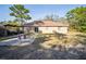 View of backyard featuring a large lawn, mature trees, and an outdoor kitchen at 12175 Phoenix Ave, Weeki Wachee, FL 34614