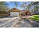 Lovely home with a two-car garage, nice front lawn, and welcoming covered front porch at 12175 Phoenix Ave, Weeki Wachee, FL 34614