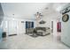 Spacious living room featuring tile flooring, a ceiling fan, and comfortable seating at 12175 Phoenix Ave, Weeki Wachee, FL 34614