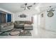 Inviting living room with modern tile flooring, a ceiling fan, and neutral paint tones at 12175 Phoenix Ave, Weeki Wachee, FL 34614