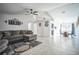 Open living area with tile floors, neutral colors, and a view into the kitchen at 12175 Phoenix Ave, Weeki Wachee, FL 34614