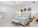 Well-lit bedroom featuring a bed with nautical themed bedding, and a stylish bench at 6354 Cocoa Ln, Apollo Beach, FL 33572