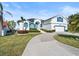 Charming two-story home with manicured lawn, circular driveway, and bright white exterior paint at 6354 Cocoa Ln, Apollo Beach, FL 33572