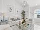 Bright living room with marble floors, a glass coffee table, and coordinated white furniture at 6354 Cocoa Ln, Apollo Beach, FL 33572