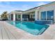 Beautiful outdoor pool with travertine deck, spa, and covered seating area, perfect for entertaining and relaxation at 6354 Cocoa Ln, Apollo Beach, FL 33572