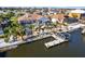 Stunning aerial view of a waterfront property with a private pool, screened-in lanai, boat dock, and lush palm trees at 818 Golf Island Dr, Apollo Beach, FL 33572