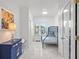 Bright bedroom featuring a blue bunk bed, tile floors, and a blue cabinet, creating a welcoming and functional space at 818 Golf Island Dr, Apollo Beach, FL 33572