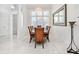 Formal dining room with marble floors, a modern chandelier, and bright light at 818 Golf Island Dr, Apollo Beach, FL 33572