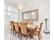 The dining room boasts marble floors, a modern chandelier, and bright natural light at 818 Golf Island Dr, Apollo Beach, FL 33572