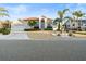 Charming single-story home featuring a manicured lawn, a two-car garage, and a welcoming front entrance at 818 Golf Island Dr, Apollo Beach, FL 33572