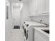 Well-organized laundry room featuring modern washer and dryer units and ample cabinet space at 818 Golf Island Dr, Apollo Beach, FL 33572