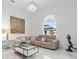 Living room featuring stylish sofa, glass coffee table, elegant lighting, and decorative pieces at 818 Golf Island Dr, Apollo Beach, FL 33572