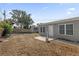 A view of the backyard with a privacy fence and a small concrete patio off of the back of the home at 8549 Oakhurst Rd, Seminole, FL 33776