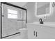 Bathroom featuring modern vanity, mirror and walk-in glass shower at 8549 Oakhurst Rd, Seminole, FL 33776