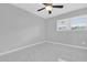 Bedroom with tile floors, ceiling fan, and bright natural light at 8549 Oakhurst Rd, Seminole, FL 33776