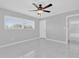 Bedroom featuring tile floors, ceiling fan, and large windows at 8549 Oakhurst Rd, Seminole, FL 33776