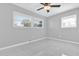 Bedroom features modern ceiling fan, tile floor, and bright windows at 8549 Oakhurst Rd, Seminole, FL 33776