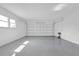 Spacious garage with epoxy flooring and bright lighting at 8549 Oakhurst Rd, Seminole, FL 33776